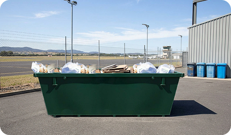 Full commercial skip bin in Cambridge filled with industrial waste ready for collection